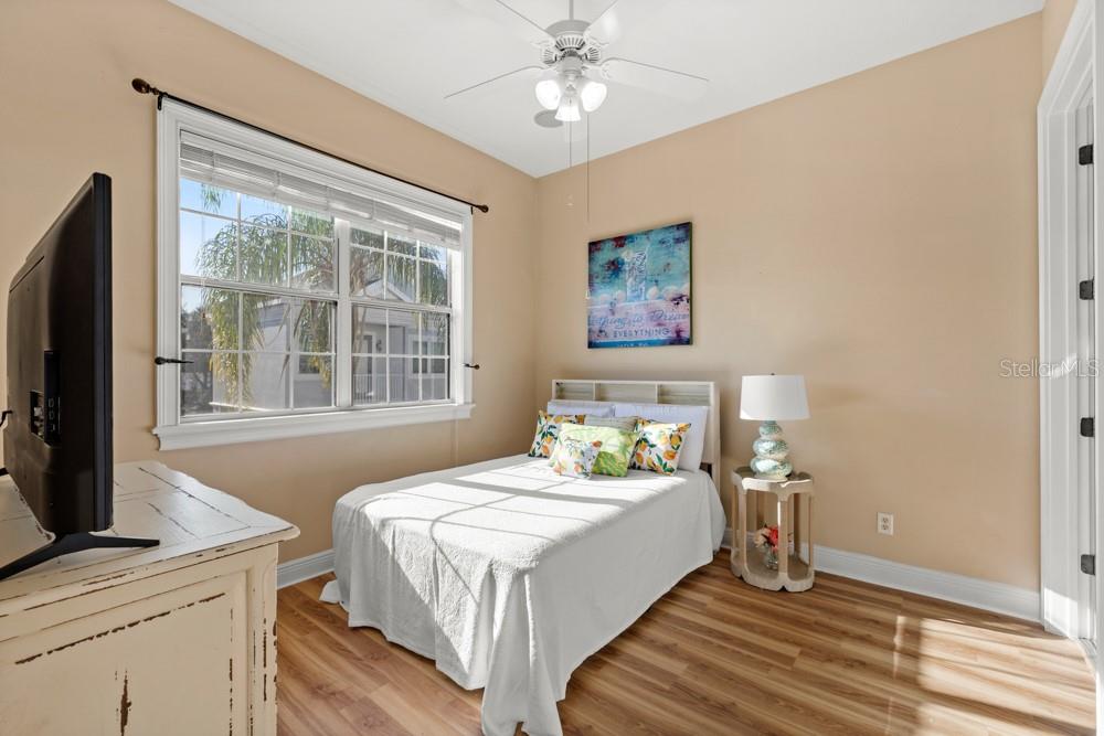 7423 Excitement Drive Reunion, FL 34747 - Photo 23 of 99 a bedroom with a bed and a flat tv screen on dresser