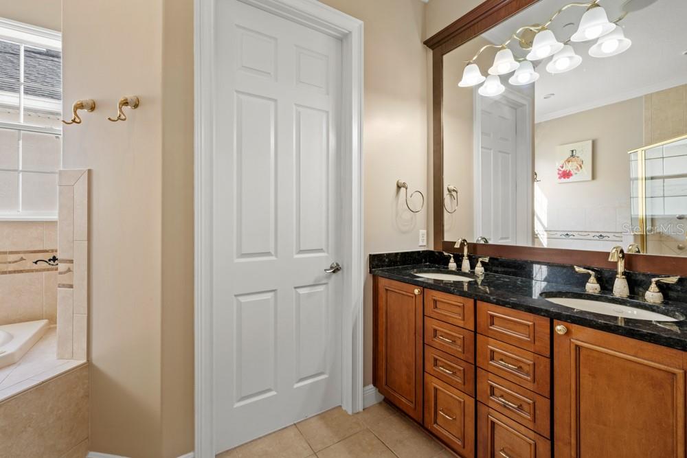 7423 Excitement Drive Reunion, FL 34747 - Photo 31 of 99 a bathroom with double sink and a mirror