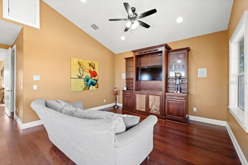 7423 Excitement Drive Reunion, FL 34747 - Photo 38 of 99 a living room with furniture and a flat screen tv