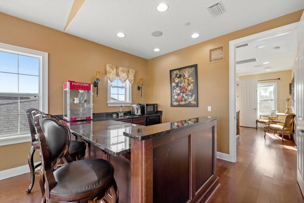 7423 Excitement Drive Reunion, FL 34747 - Photo 39 of 99 a view of a workspace with furniture and wooden floor