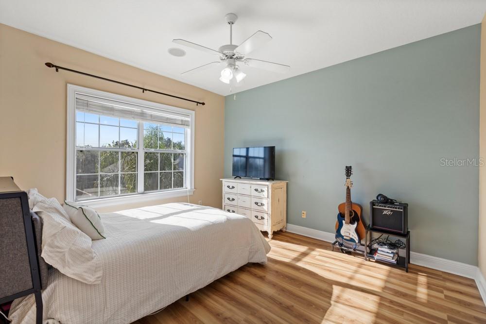 7423 Excitement Drive Reunion, FL 34747 - Photo 49 of 99 a bedroom with a bed and a table in it