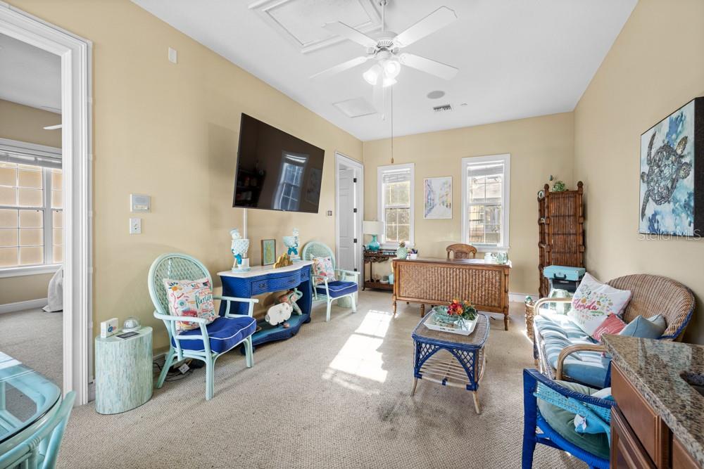 7423 Excitement Drive Reunion, FL 34747 - Photo 58 of 99 a living room with furniture and a flat screen tv