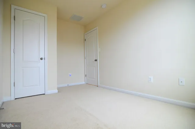 a view of staircase with white walls