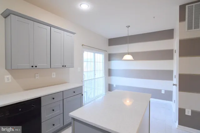 a kitchen with white cabinets
