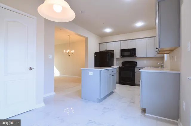 a kitchen with cabinets and stainless steel appliances