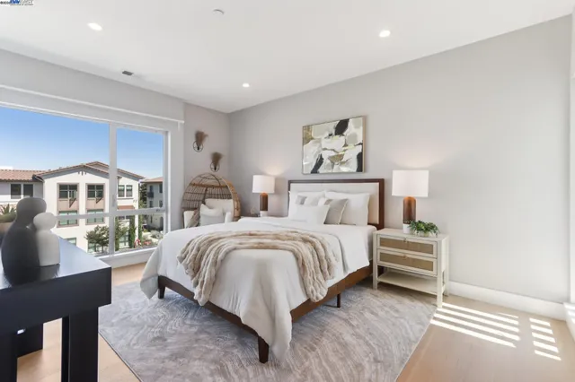 a bedroom with a bed and a large window