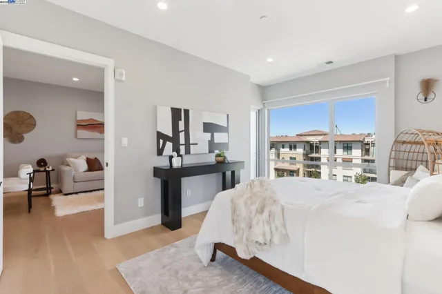 a living room with a bed furniture and a large window