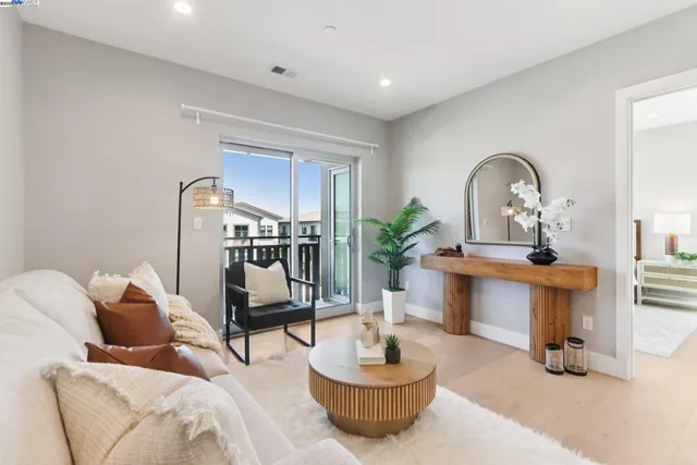 a living room with furniture and a potted plant