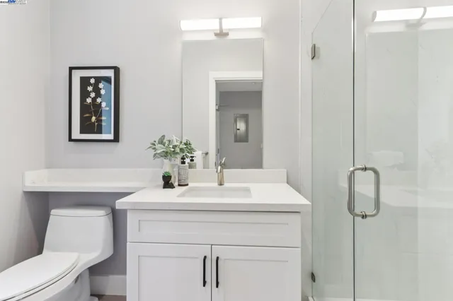 a bathroom with a sink vanity and toilet