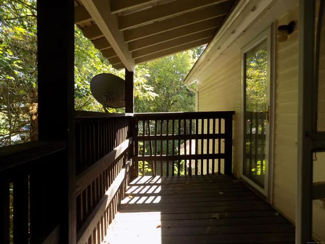 a view of balcony with wooden floor
