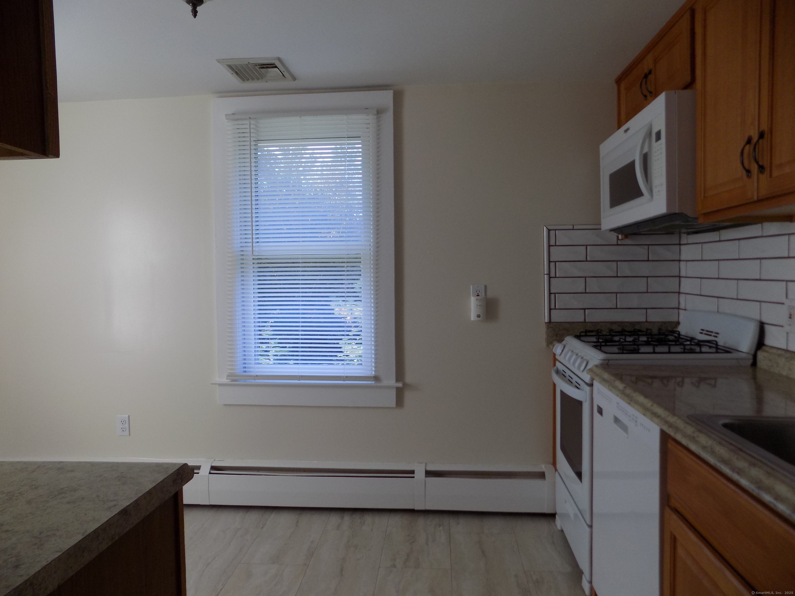 6 Hillside Avenue, Unit B New Milford, CT 06776 - Photo 2 of 12 a kitchen with a stove and a microwave