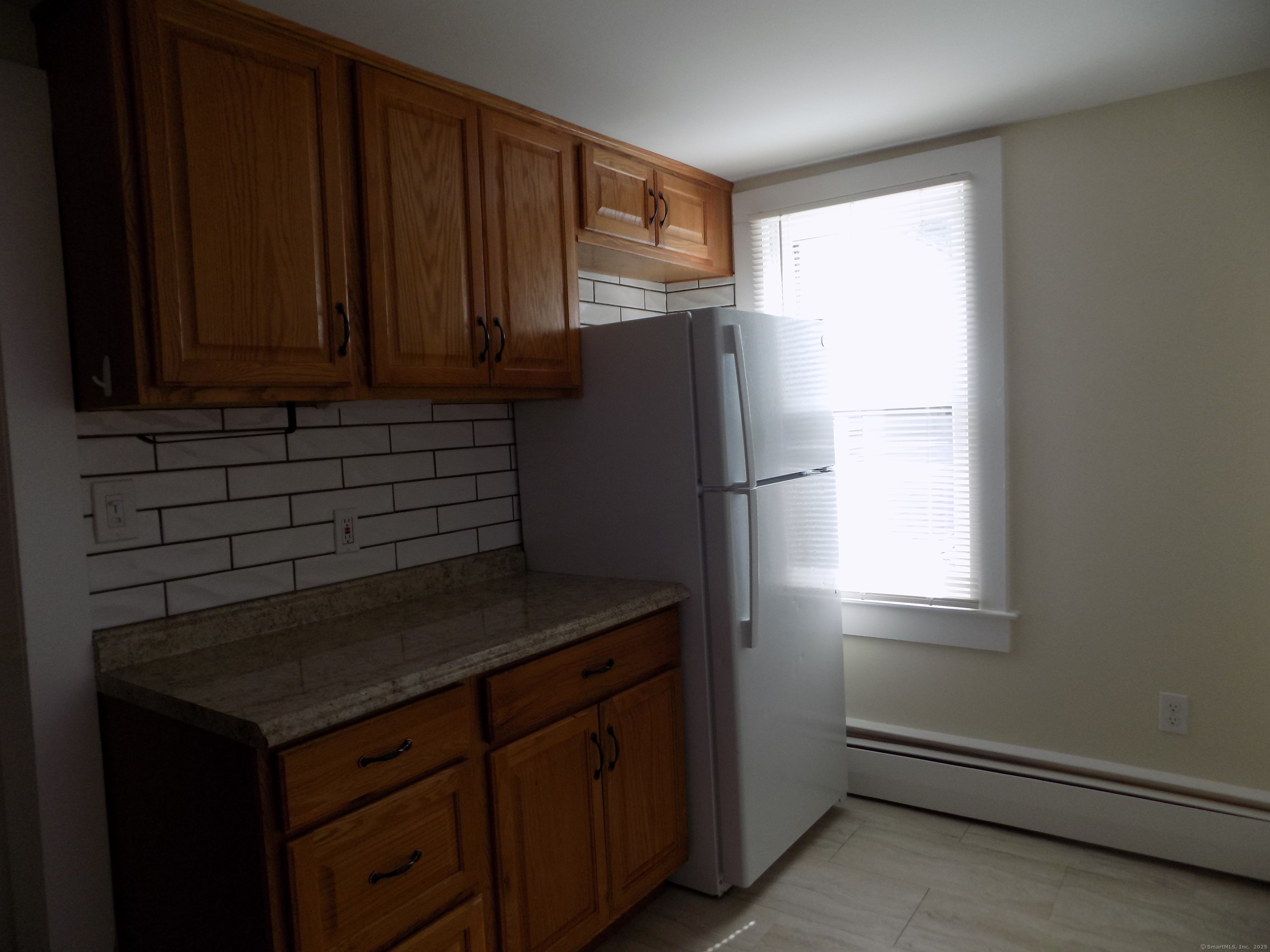 6 Hillside Avenue, Unit B New Milford, CT 06776 - Photo 3 of 12 a kitchen with a refrigerator and cabinets