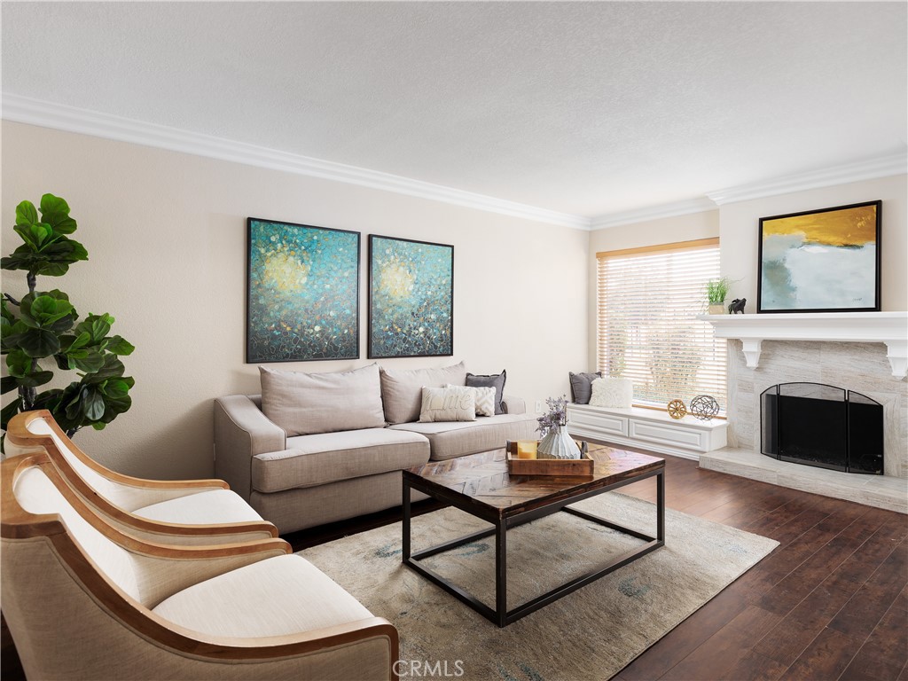 a living room with furniture a window and a fireplace