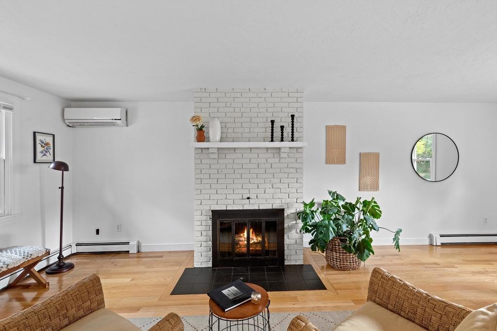 12 State Road, Unit 3D Plymouth, MA 02360 - Photo 18 of 30 a living room with furniture a fireplace and a potted plant