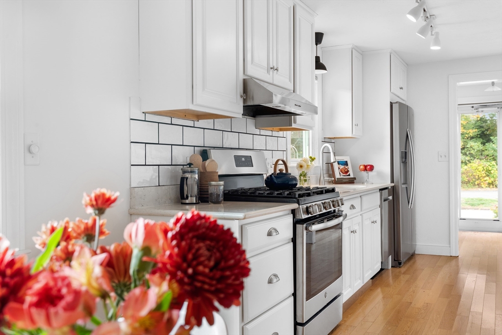 12 State Road, Unit 3D Plymouth, MA 02360 - Photo 9 of 30 a kitchen with stainless steel appliances granite countertop a sink stove and refrigerator