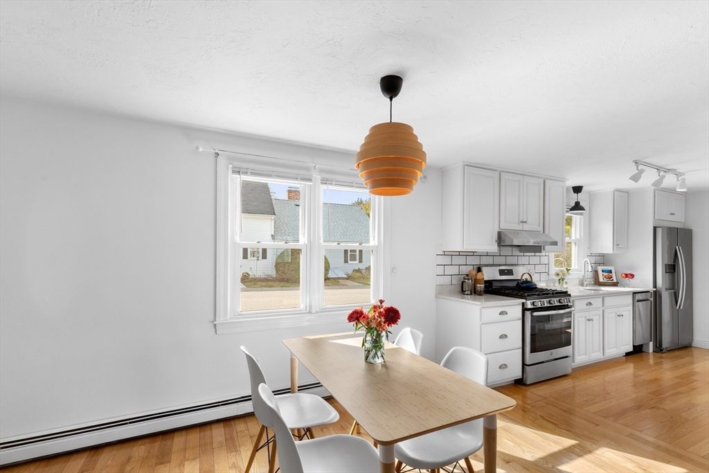 12 State Road, Unit 3D Plymouth, MA 02360 - Photo 10 of 30 a kitchen with stainless steel appliances granite countertop a stove top oven a sink dishwasher and a refrigerator with wooden floor