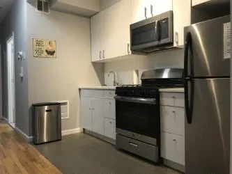 a kitchen with stainless steel appliances a refrigerator stove and microwave