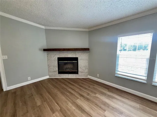 a view of empty room with a fireplace
