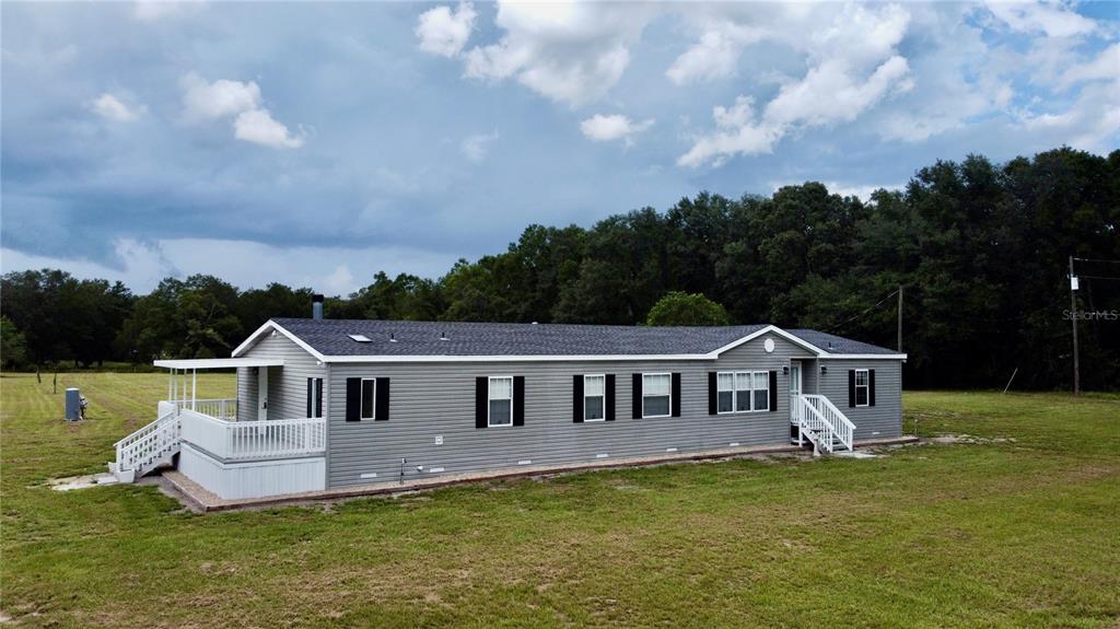 1070 Southwest Mauldin Avenue Lake City, FL 32024 - Photo 2 of 31 a aerial view of a house next to a big yard and large trees
