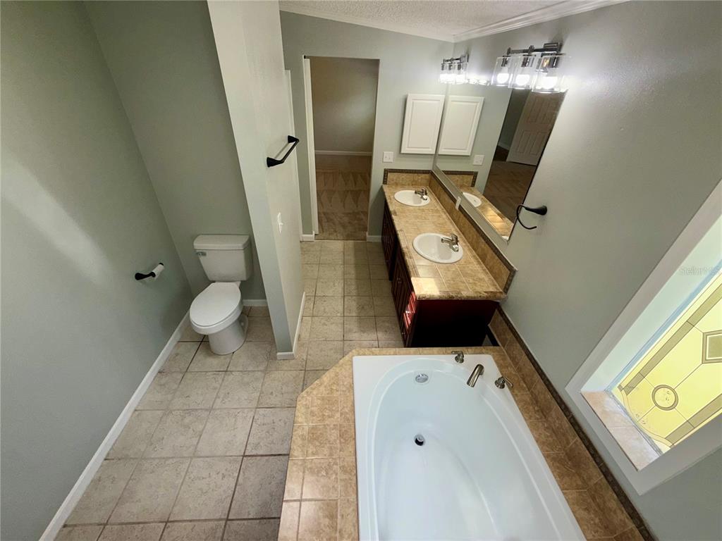 1070 Southwest Mauldin Avenue Lake City, FL 32024 - Photo 24 of 31 a bathroom with a toilet sink and mirror