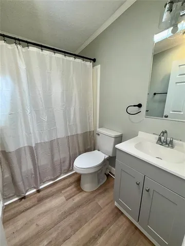 a bathroom with a toilet a sink and a shower