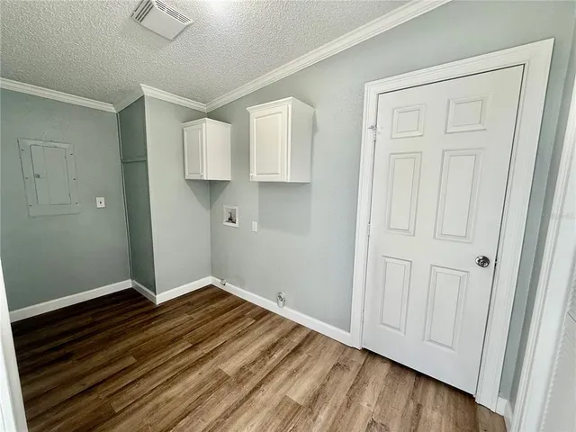 a view of empty room with wooden floor