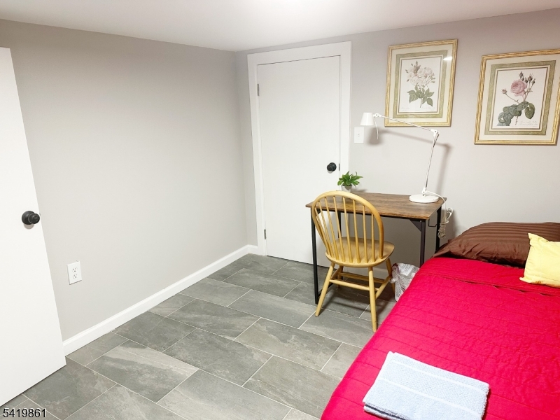 34 Duryea Street Newark, NJ 07103 - Photo 14 of 15 a bedroom with a bed and a chair