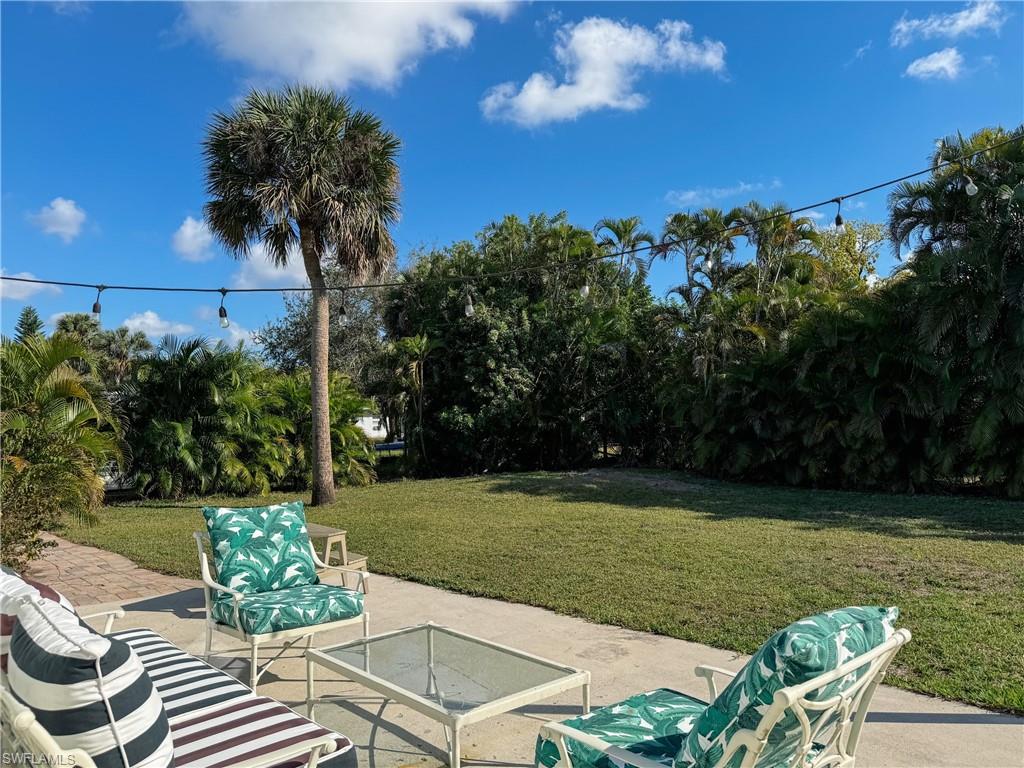 2440 Clipper Way Naples, FL 34104 - Photo 11 of 11 a view of a chairs and table in the garden