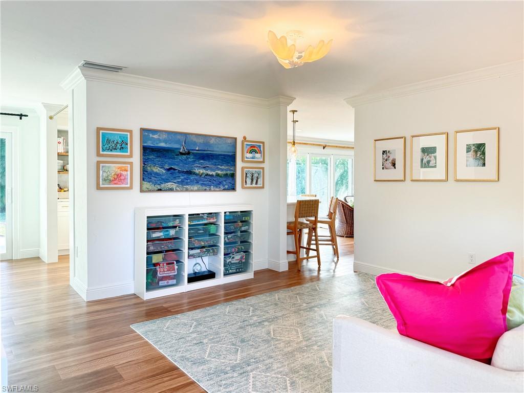 2440 Clipper Way Naples, FL 34104 - Photo 2 of 11 a living room with furniture and a fireplace