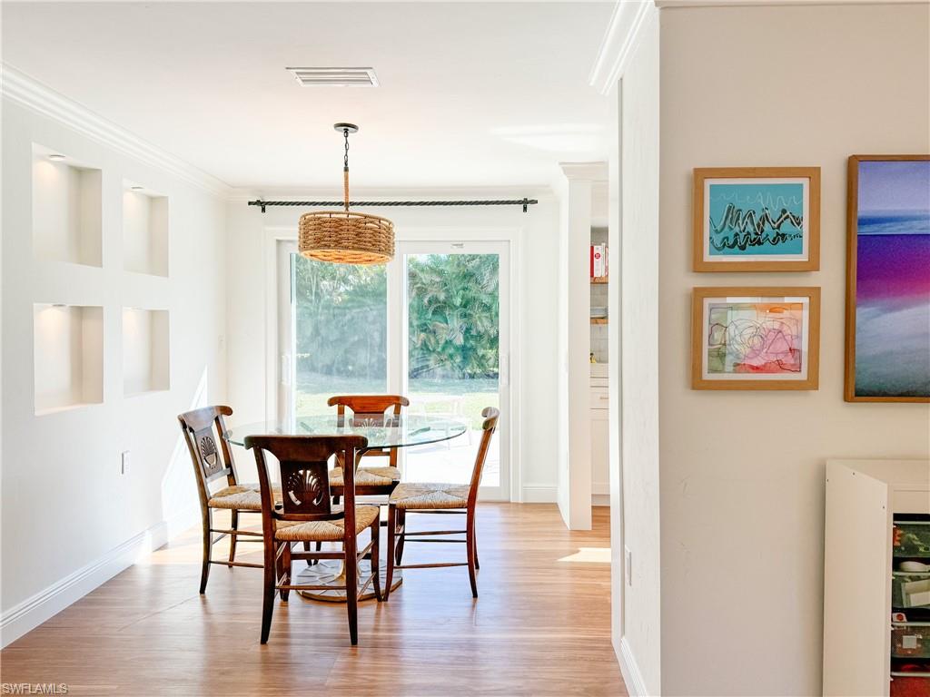 2440 Clipper Way Naples, FL 34104 - Photo 3 of 11 a dining room with furniture window wooden floor