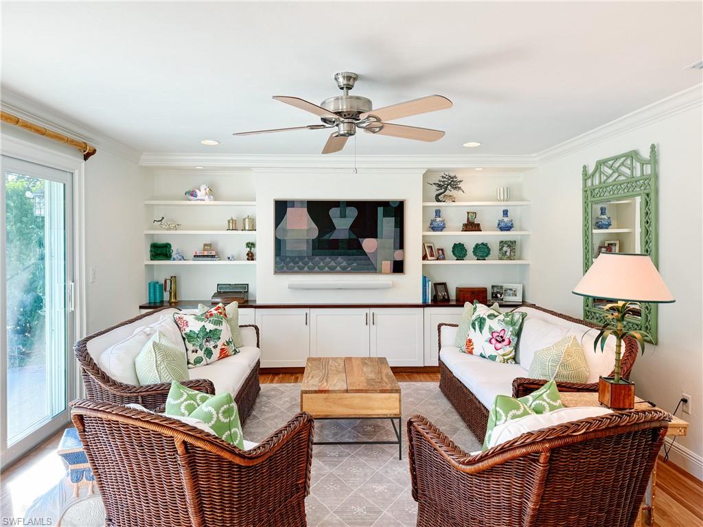 2440 Clipper Way Naples, FL 34104 - Photo 6 of 11 a living room with furniture and a chandelier