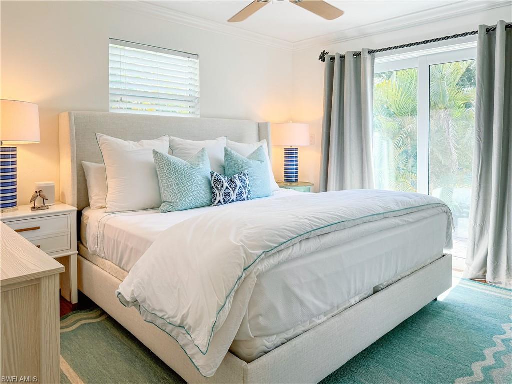 2440 Clipper Way Naples, FL 34104 - Photo 7 of 11 a large bed sitting in a bedroom next to a window