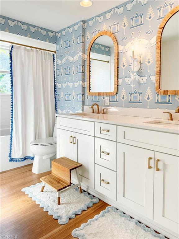 2440 Clipper Way Naples, FL 34104 - Photo 8 of 11 a bathroom with a sink a mirror and a window