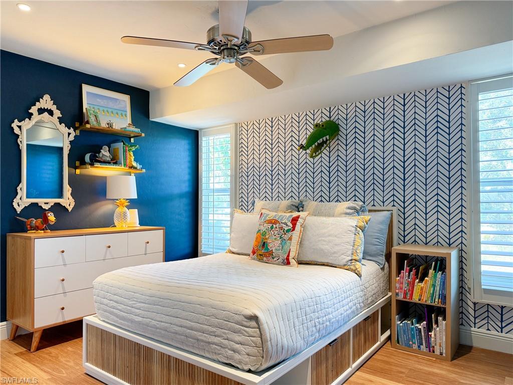 2440 Clipper Way Naples, FL 34104 - Photo 9 of 11 a bedroom with a bed and a chandelier