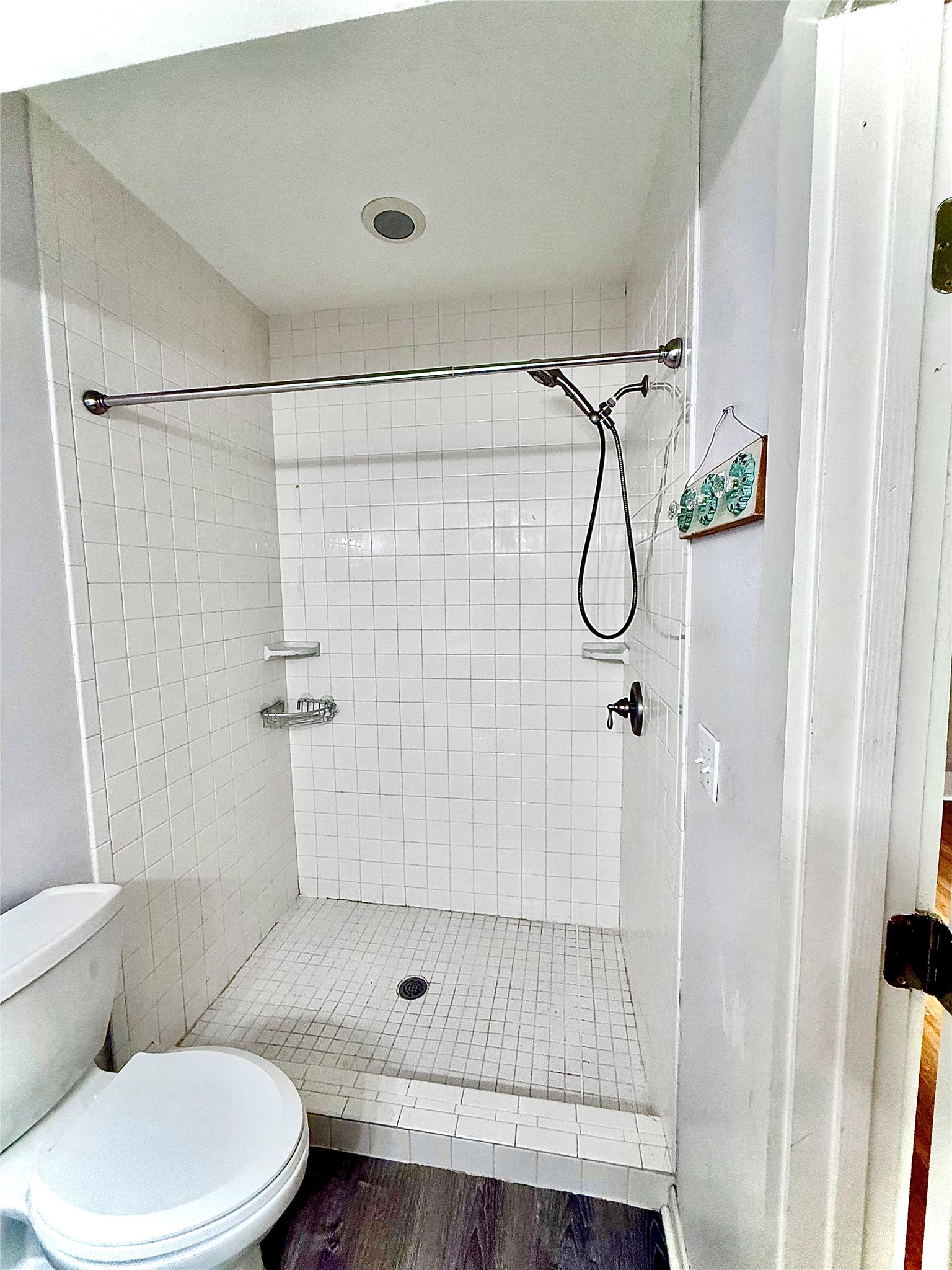 423 South Main Street Lockhart, TX 78644 - Photo 12 of 26 Walk-in shower featuring white subway tile walls and a white square tile floor