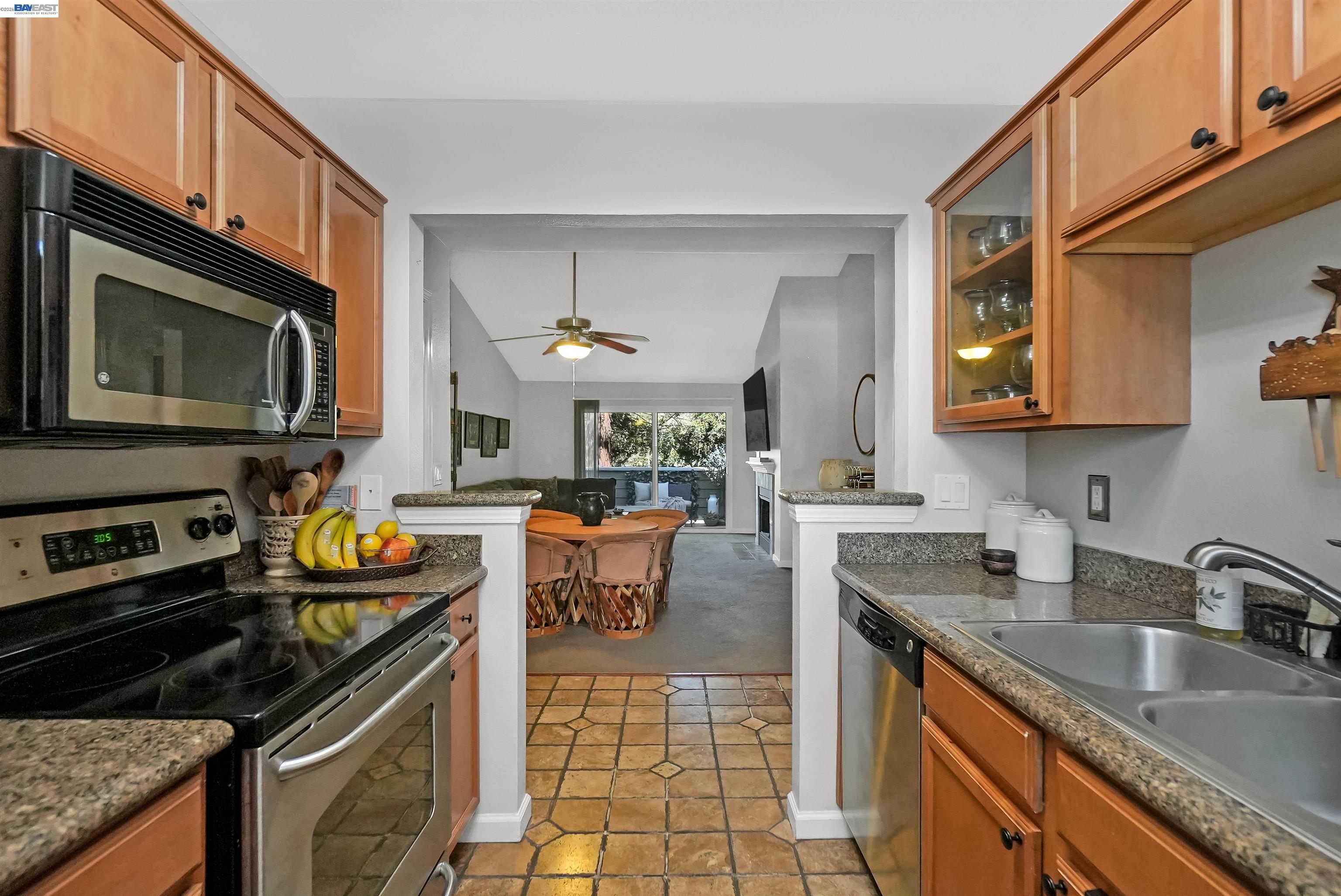 200 Reflections Drive, Unit 23 San Ramon, CA 94583 - Photo 25 of 56 a kitchen with stainless steel appliances granite countertop a stove top oven a sink a dining table and chairs