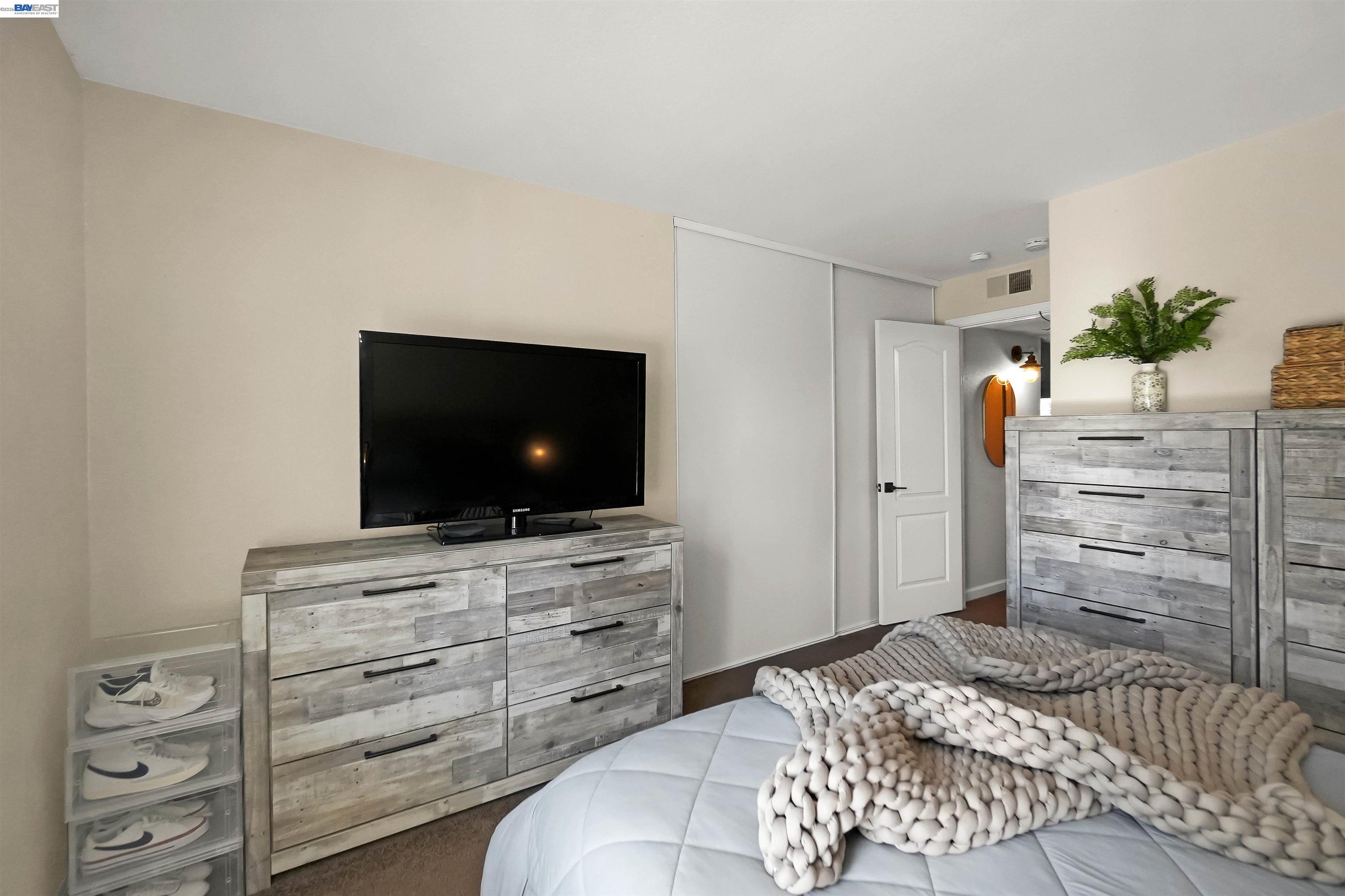 200 Reflections Drive, Unit 23 San Ramon, CA 94583 - Photo 31 of 56 a bedroom with a bed and flat screen tv
