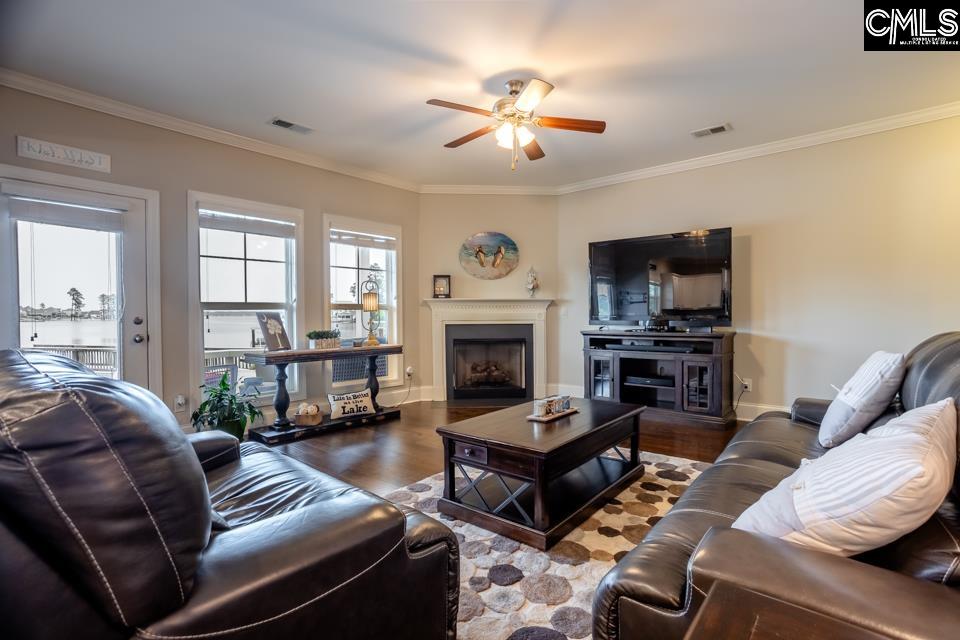 357 Cabana Way Lexington, SC 29072 - Photo 8 of 25 a living room with furniture a fireplace and a flat screen tv