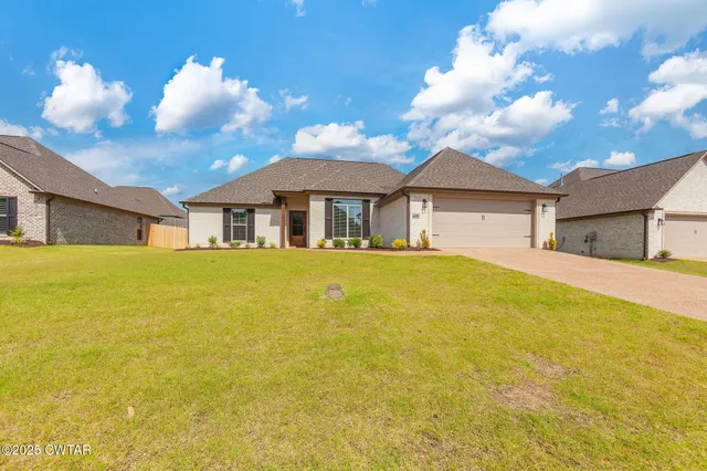 a front view of house with an outdoor space and seating area