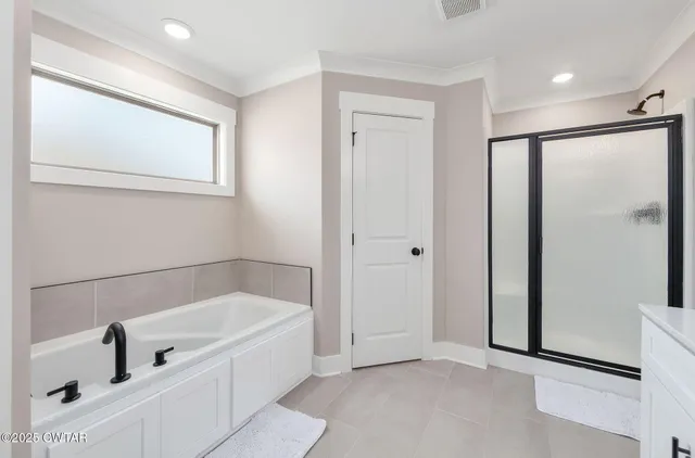 a bathroom with a bathtub and shower