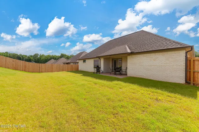 a house view with swimming pool and trees in the background