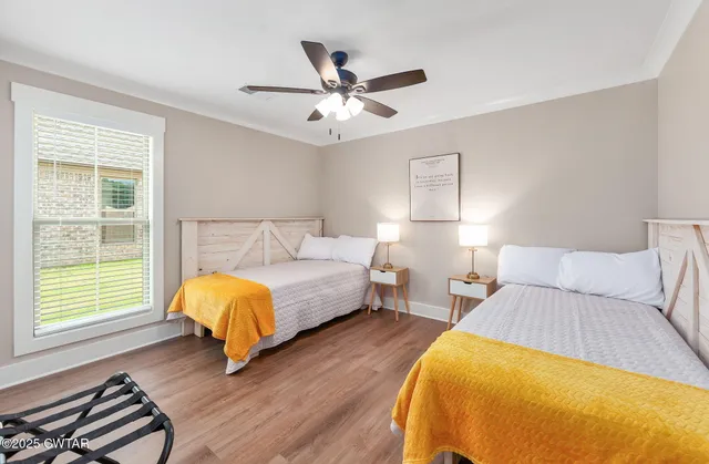 a bedroom with a bed and wooden floor