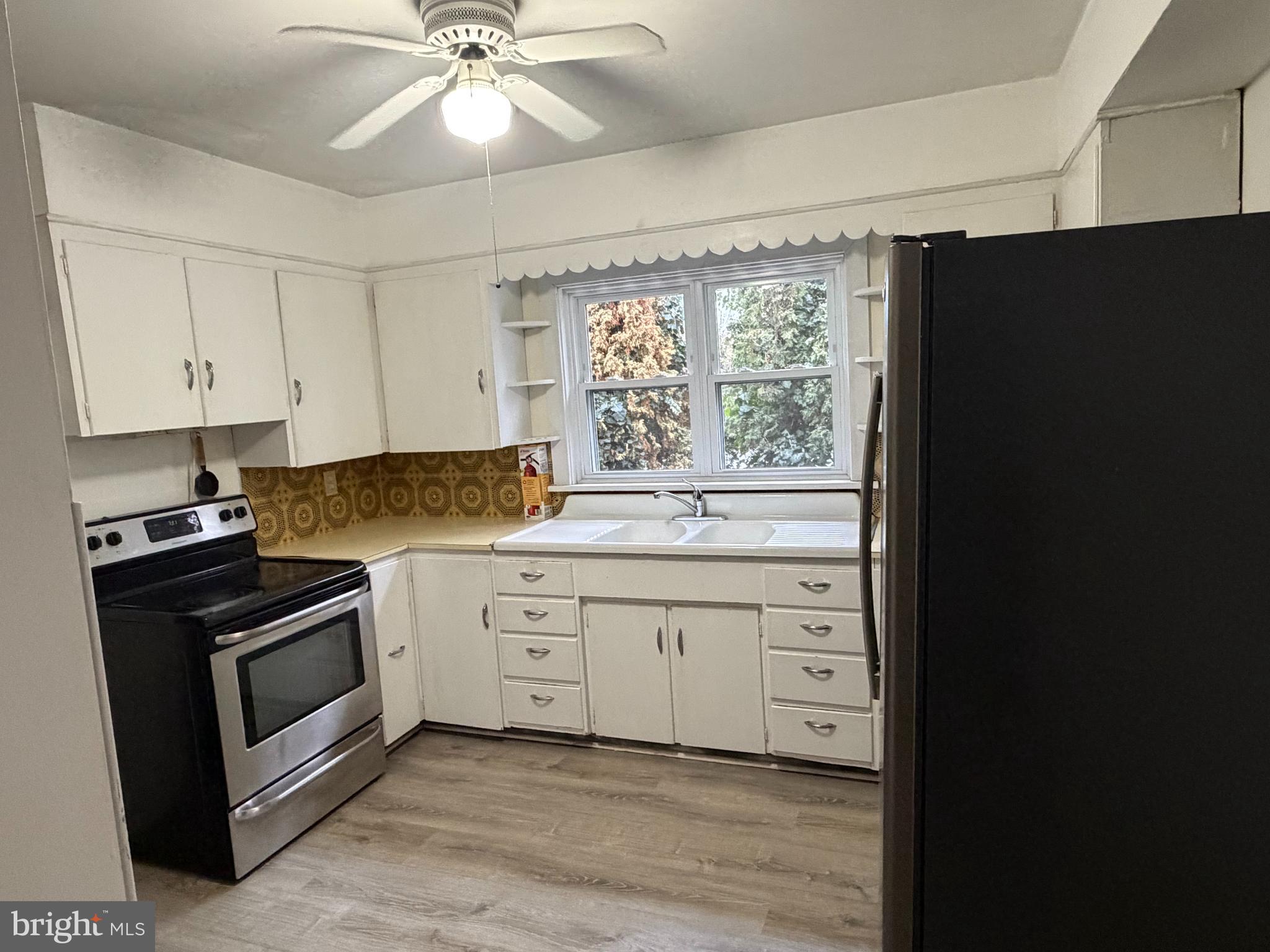 333 East Locust Street Lebanon, PA 17042 - Photo 5 of 17 a kitchen with white cabinets and a stove