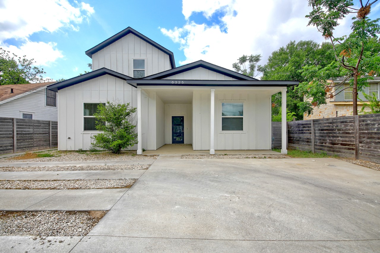 View of front of home featuring board and batten siding and a porch