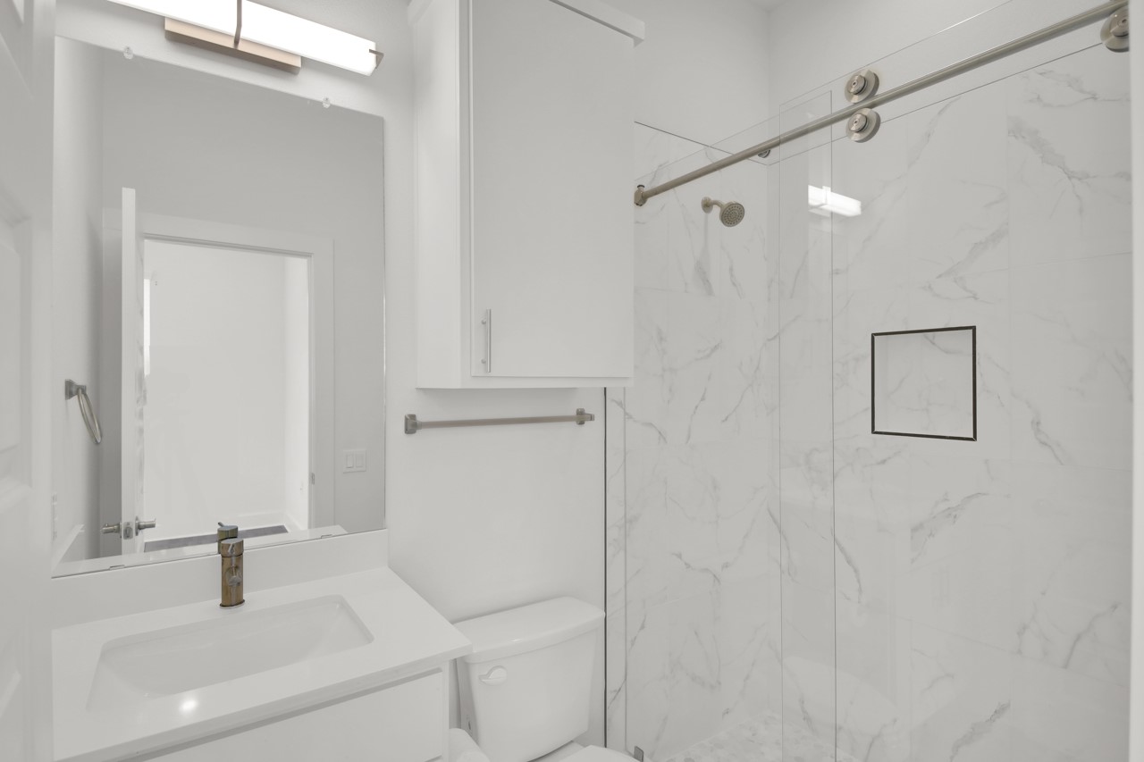 6325 Ponca Street, Unit B Austin, TX 78741 - Photo 16 of 29 Bathroom with vanity and a marble finish shower