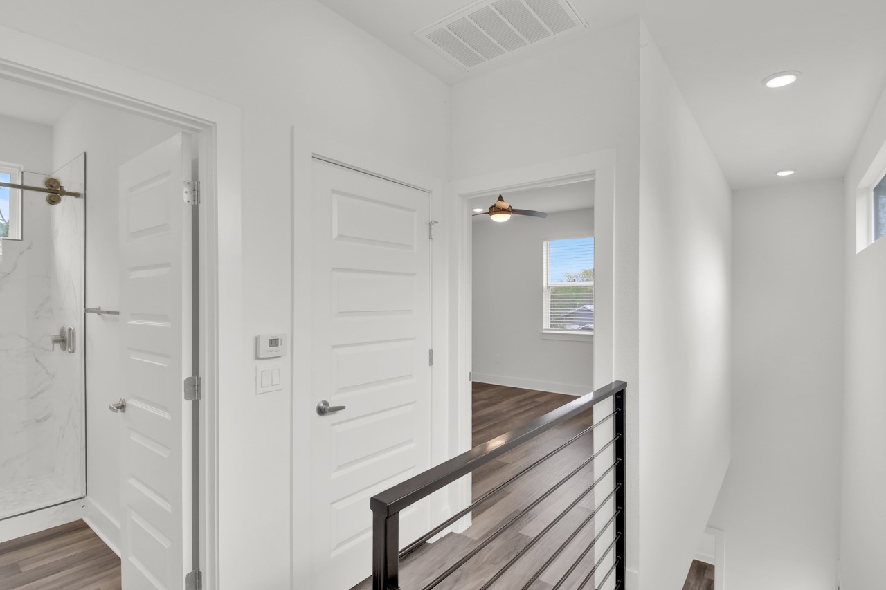 6325 Ponca Street, Unit B Austin, TX 78741 - Photo 18 of 29 Hall with an upstairs landing, healthy amount of natural light, dark wood-style flooring, and recessed lighting