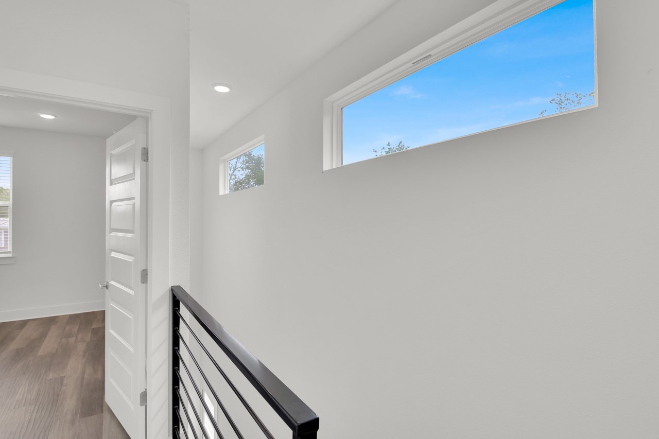 6325 Ponca Street, Unit B Austin, TX 78741 - Photo 20 of 29 Corridor featuring dark wood-style flooring, recessed lighting, and plenty of natural light