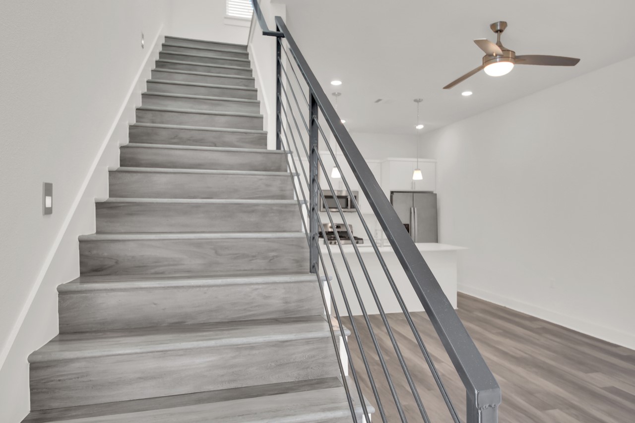 6325 Ponca Street, Unit B Austin, TX 78741 - Photo 2 of 29 Staircase with a ceiling fan, recessed lighting, and wood finished floors