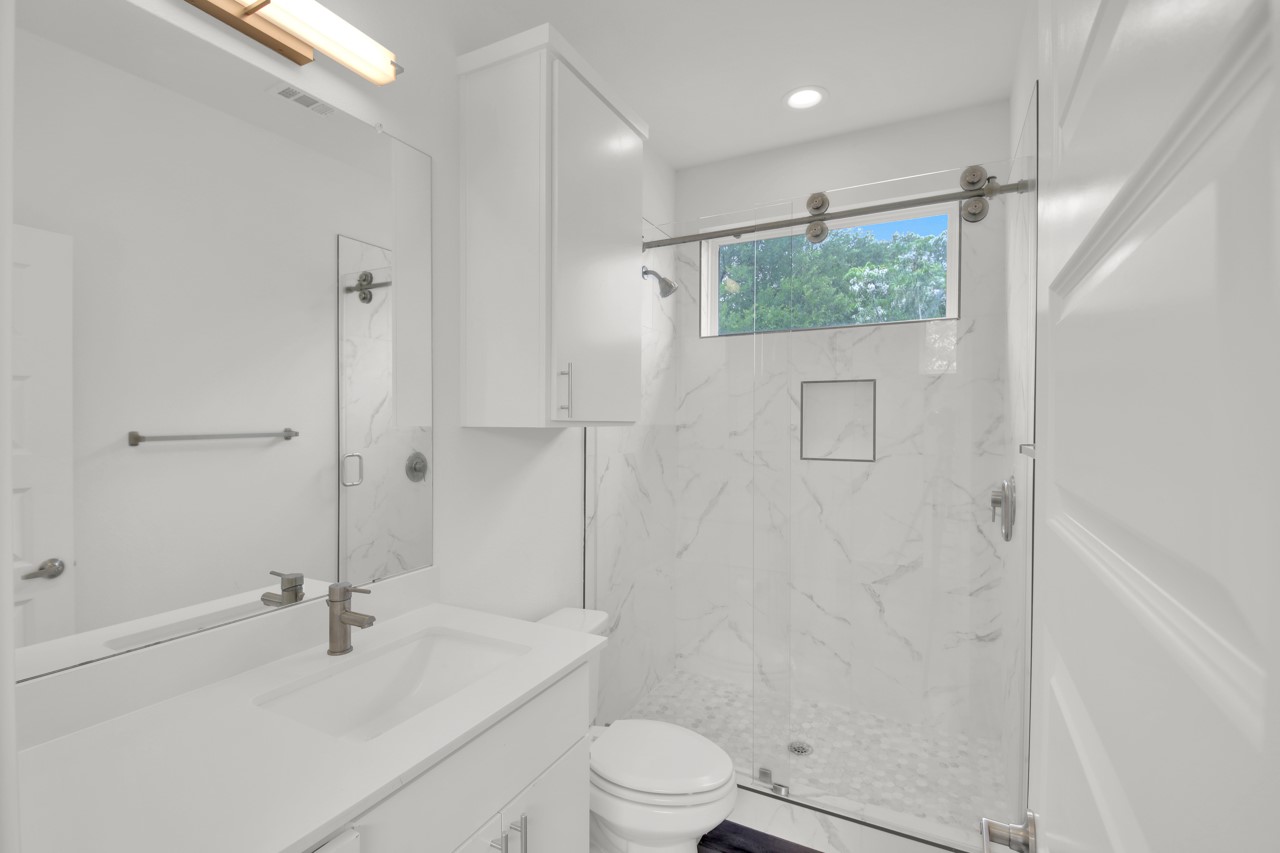 6325 Ponca Street, Unit B Austin, TX 78741 - Photo 21 of 29 Bathroom featuring vanity, a marble finish shower, and recessed lighting
