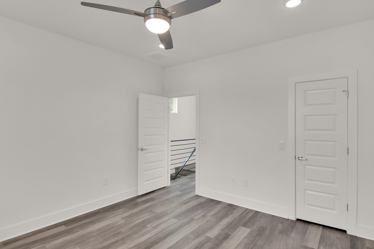 6325 Ponca Street, Unit B Austin, TX 78741 - Photo 24 of 29 Unfurnished bedroom with light wood-style flooring and a ceiling fan